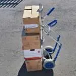 Professional removal sack truck loaded with moving boxes ready for transport