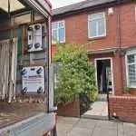 Heavy item positioned on machinery skates outside property during professional removal